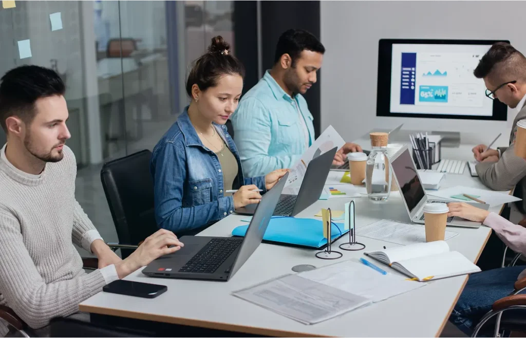 group of people working on a single table